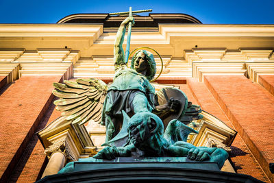 Low angle view of statue against blue sky