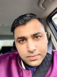 Portrait of young man in car