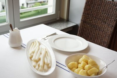 White asparagus and boiled potatoes on table at home