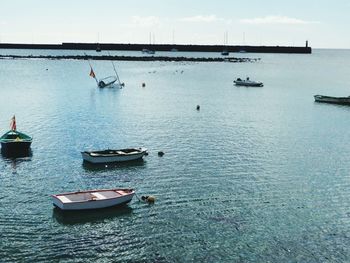 Boats in sea against sky