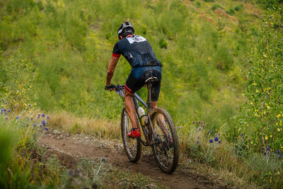 Man riding bicycle on field