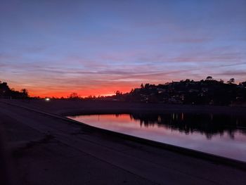 Scenic view of lake against romantic sky at sunset