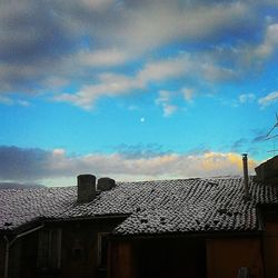 Low angle view of house against cloudy sky