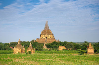 View of temple on field against sky