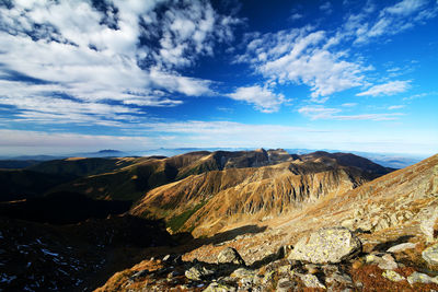 Scenic view of mountains against blue sky