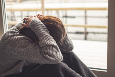Portrait of woman relaxing in park during winter
