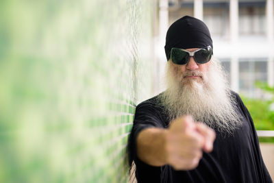 Portrait of man wearing sunglasses standing outdoors