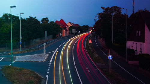 Light trails on road against sky in city