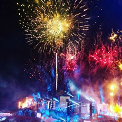 Low angle view of firework display at night