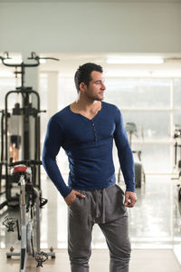 Muscular man standing in gym