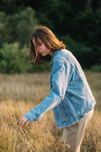 Side view of woman standing on field