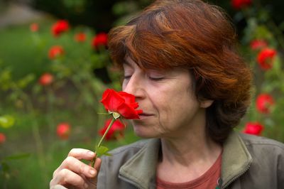 Close-up of a mature woman with a rose