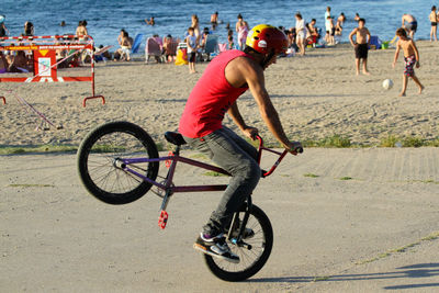 Man riding bicycle at beach