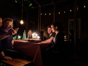 People sitting in restaurant at night