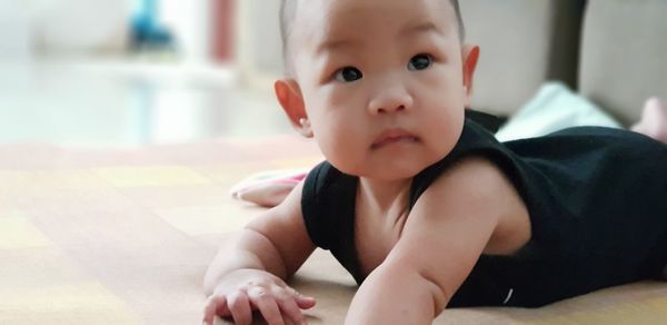 Portrait of cute boy sitting at home