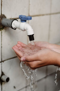 Low section of person washing hands