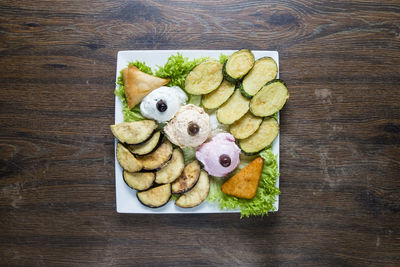 High angle view of chopped fruits in plate on table