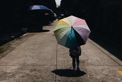 Full length of woman holding umbrella