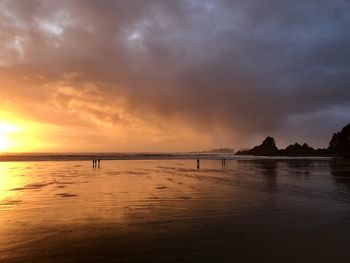 Scenic view of beach against sky during sunset