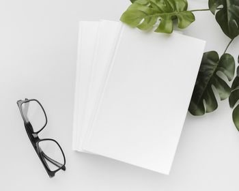 High angle view of eyeglasses on table against white background