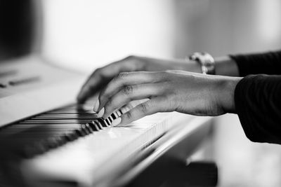 Midsection of man playing piano