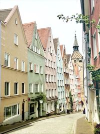 Street amidst buildings in town against sky