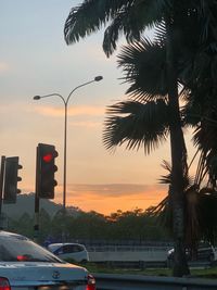 Cars on road at sunset