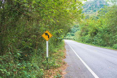 Road sign by trees