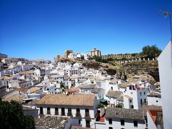 High angle view of townscape against blue sky