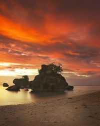 Scenic view of sea against orange sky