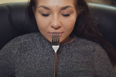 Portrait of young woman drinking water