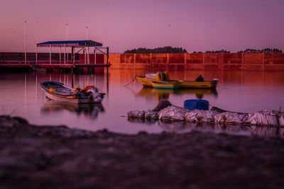 Boats moored in lake against sky