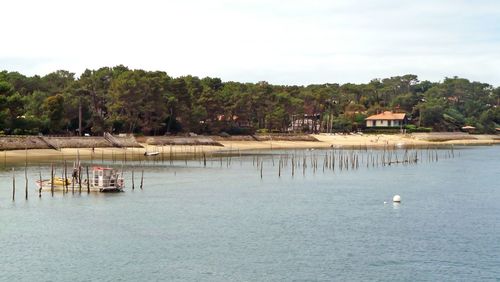 Scenic view of sea and buildings against sky