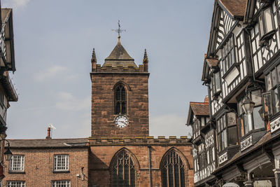 Low angle view of buildings against sky in city, chester 