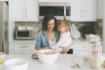 Mother and daughter making a cake together