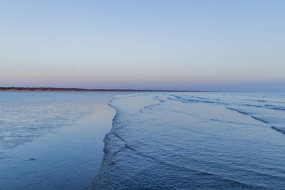 Scenic view of sea against clear sky during winter