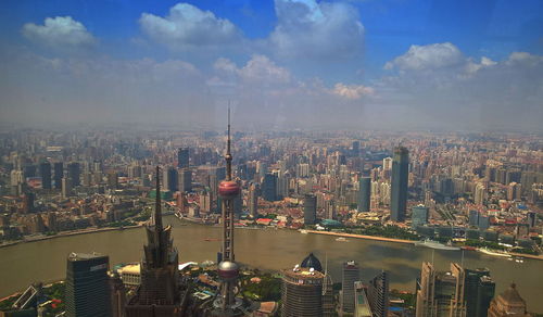 Aerial view of modern buildings in city against sky