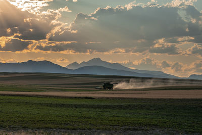 Scenic view of field against sky during sunset