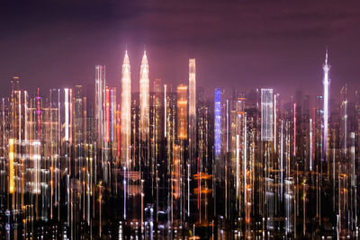 Illuminated modern buildings against sky at night