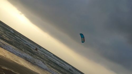 Silhouette of people against cloudy sky