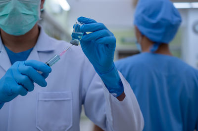 Rear view of two people holding hands