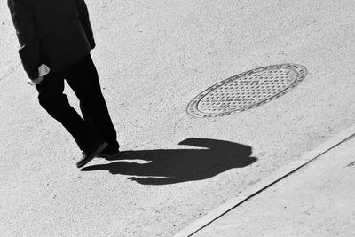 Low section of man walking on street