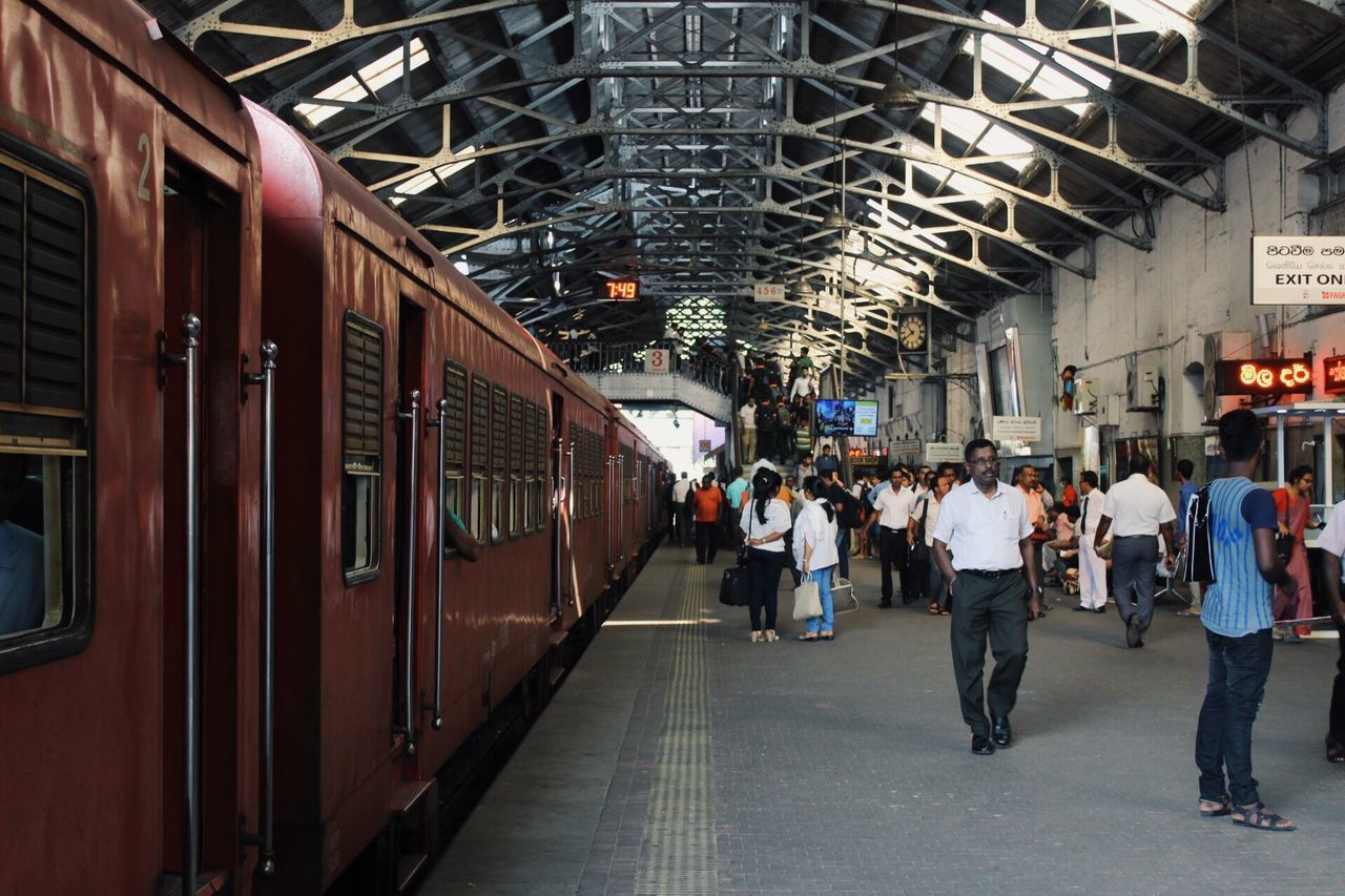 rail transportation, transportation, architecture, train, travel, mode of transportation, public transportation, railroad station, train - vehicle, group of people, real people, railroad station platform, men, built structure, passenger train, people, adult, indoors, motion, city, ceiling, subway train