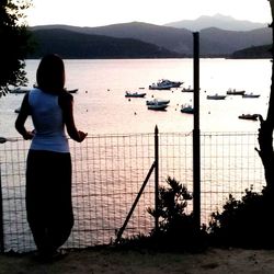 Scenic view of lake by mountains against sky