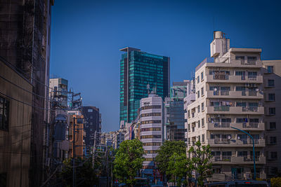 Low angle view of buildings against clear blue sky