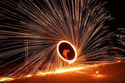 Low angle view of firework display at night