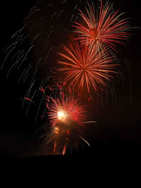 Low angle view of firework display at night