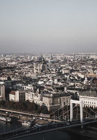 High angle view of bridge and buildings against clear sky