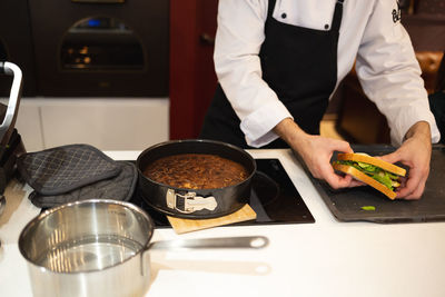 Midsection of chef preparing food in kitchen