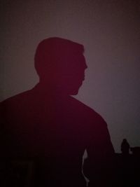 Silhouette of man against gray background